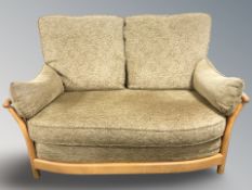 An Ercol elm thee piece lounge suite comprising of two seater settee,