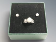 A silver and opaline dress ring, and matching pair of stud earrings.