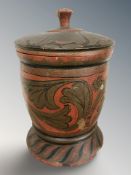 A painted wooden lidded pot, height 40 cm.