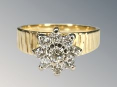 An 18ct yellow gold nine stone diamond cluster ring, size K.