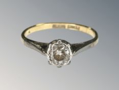 An 18ct yellow gold platinum set diamond solitaire ring, approximately 0.15ct, size J.