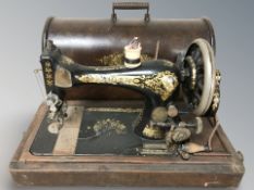 A Singer sewing machine in oak case.