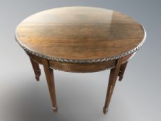 A pair of reproduction mahogany demi lune console tables in the George III style,