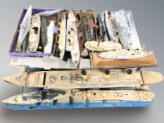 A quantity of partially built model boat hulls including warships, passenger ships, etc.