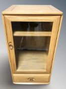 An Ercol light elm glazed door music cabinet, 51 cm x 48 cm x 103 cm.