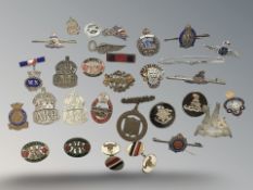 A collection of military badges including examples in silver.