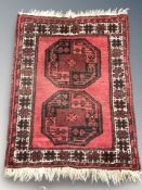 A Turkoman rug, Afghanistan, 86 cm x 64 cm, together with a similar smaller rug.