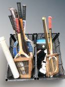 A group of vintage tennis rackets and other sports items.