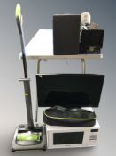 A G Tech vacuum cleaner, Panasonic microwave and a Linsar TV with remote.