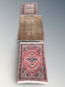 A Bokhara rug, Afghanistan, 107 cm x 77 cm, together with two further smaller Iranian rugs.