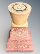 A large champagne cork stool, height 47 cm,