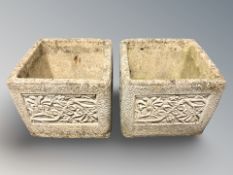 A pair of concrete square planters,
