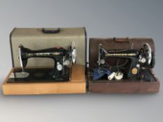 A Singer electric sewing machine and a further hand sewing machine, in boxes.