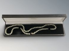 A single strand green cultured pearl necklace with 9ct gold clasp, length 46 cm.