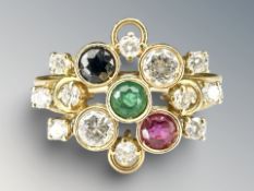 An 18ct yellow gold emerald, diamond, ruby and sapphire ring.