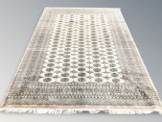 A Lahore Bokhara carpet, Pakistan, signed to one corner, 327 cm x 224 cm.