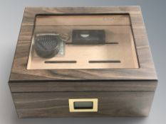 A Cigarol tabletop cigar humidor, and a multi function lighter / cutter.