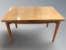 A 20th teak extending dining table,