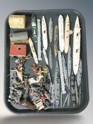 A group of miniature die cast battleships, buildings, farm animals, etc.