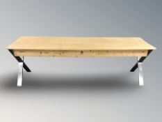 A contemporary pine and brushed metal side table, fitted a drawer,