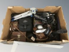 A group of joysticks, camera tripods, cameras including Agfa, etc.