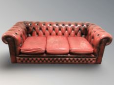 A Chesterfield oxblood leather three seater club settee,