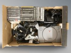 A Sony Playtstation 1, controllers, driving wheel and pedal, and a quantity of games.