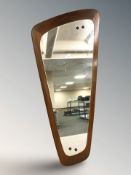 A 1970's teak asymmetrical wall mirror,
