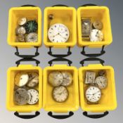 A group of watch faces and movements including a rectangular-cased stainless steel wristwatch with