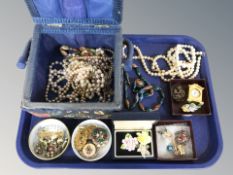 A collection of costume jewellery, decorative enameled brooches, simulated pearls,