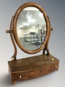 A Victorian mahogany bow-front dressing table mirror, fitted three drawers,