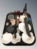 A group of shells, torch, magnifying glasses, cigars, lighter, two knives in plastic sheathes, etc.