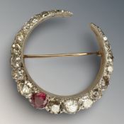 A fine quality ruby and diamond crescent brooch, set with 22 diamonds, approximately 6cts,