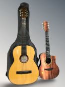 An acoustic guitar and a half sized guitar