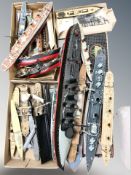 A quantity of part-built scale model ships.