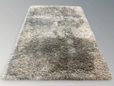 A contemporary shaggy piled grey rug, 203 cm x 141 cm.