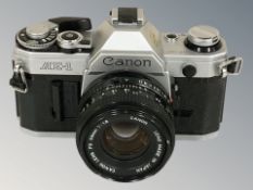 A Canon AE-1 camera with Canon 50mm 1:1.8 lens.