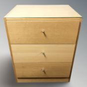 An oak veneered MDF three drawer chest, width 64 cm.