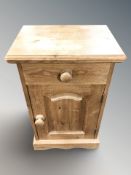 A modern pine bedside pot cupboard,
