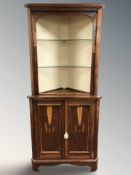 A reproduction yew wood standing corner cabinet with glass shelves, height 181 cm.