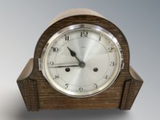 An Enfield Art Deco oak cased mantle clock striking on a gong with pendulum and key,