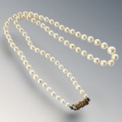 A strand of pearls with gold clasp