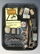 A group of car badges, die cast models, Players navy cut tin, clock keys, warning sign, etc.