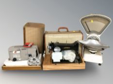 A Jones sewing machine, a set of grocer's scales and an Olympus projector.