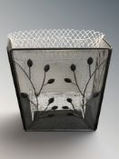 A modern wire metal firescreen and a painted wire metal planter.