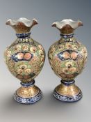 A pair of early 20th century Indo-Persian papier-maché vases, height 25 cm.