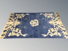 A Chinese rug depicting dragons, 224 cm x 127 cm.