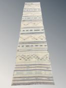 An Eastern flatweave Kilim runner, 379 cm x 82 cm.