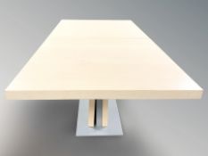A contemporary laminated wood pedestal dining table,