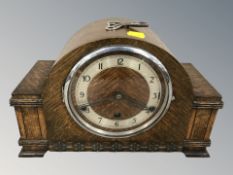 An Art Deco oak eight day chiming mantel clock with silvered dial, with pendulum and key,